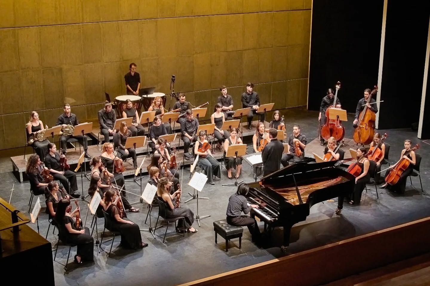 Youth orchestra performing on stage