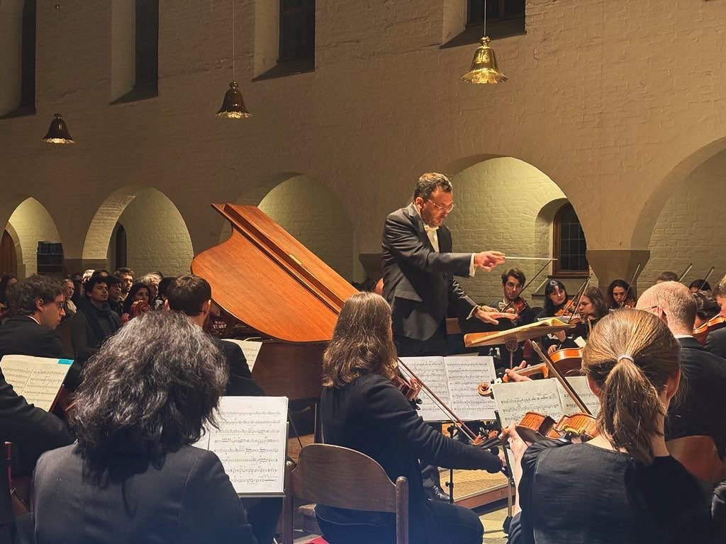 Orchestra with piano on stage